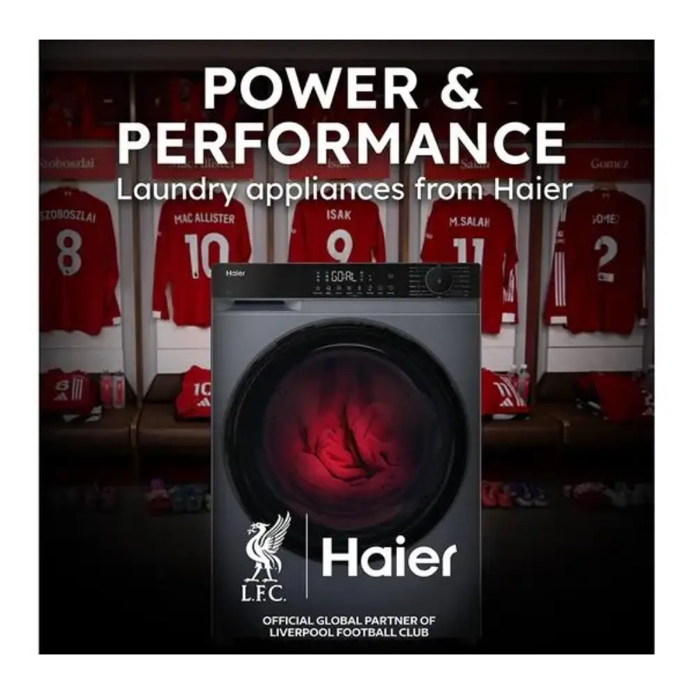 Haier washing machine advertising image showing a dark grey front-load washer with red glowing drum, displayed against Liverpool FC jersey background with players' shirts, featuring "Power & Performance" headline and LFC official global partner branding