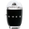 Smeg 50's retro style black electric citrus juicer with chrome details and clear dome lid, featuring stainless steel cone reamer and white SMEG branding