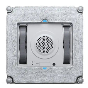 Ecovacs Winbot Mini robot window vacuum cleaner with beige fabric frame, white central unit featuring circular speaker grille, dark side panels, and blue accent dots, mounted on textured light gray background with silver corner fasteners