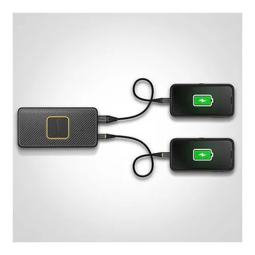 Otterbox 15000mAh black power bank with carbon fiber texture charging two smartphones via USB cables, both phones displaying green battery icons on screens