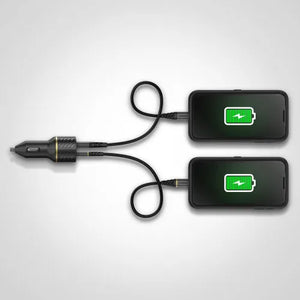 Otterbox dual port car charger in black with USB-C and USB-A ports connected to two smartphones displaying green battery icons, featuring a car cigarette lighter adapter on left side