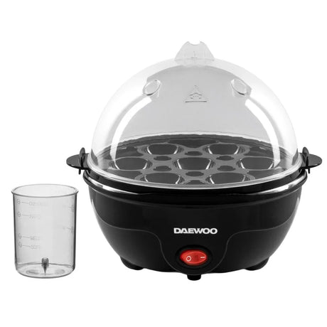 Daewoo black electric egg cooker with clear dome lid, capacity for 7 eggs, featuring red power button, transparent water measuring cup with fill markers, and stainless steel handles on white background