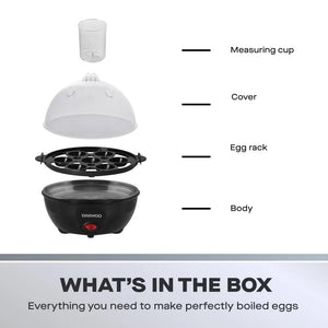 Daewoo black electric egg cooker with 7-egg capacity showing component parts including measuring cup, clear dome cover, black egg rack, and main body with red power button, labeled "What's in the Box"