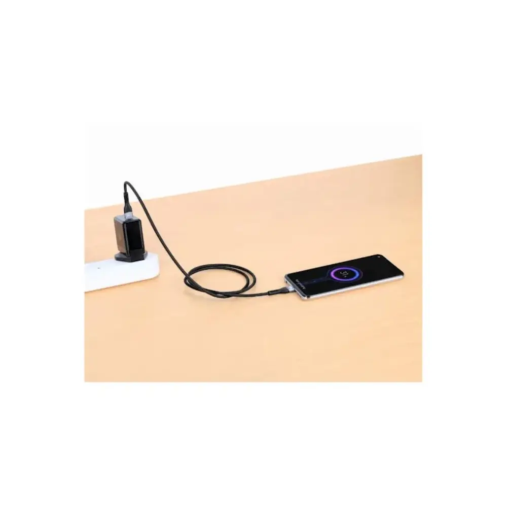 Black USB-C to USB-C charging cable connected between a wall-mounted power adapter and smartphone on wooden desk surface, demonstrating 240W fast charging capability