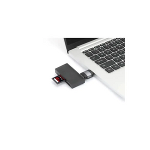 Black USB-C to USB-A dual adapter connected to silver MacBook laptop showing SD card slot and USB ports
