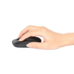 Hand holding a black wireless optical USB mouse with three buttons and scroll wheel against a white background