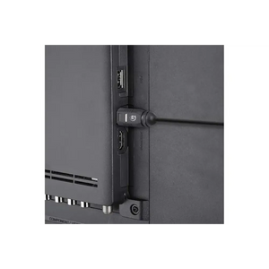 Black digital optical audio cable with Toslink connectors attached to electronic equipment showing cable management and connection detail