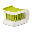 Joseph Joseph BladeBrush Knife Cleaner in green and white with soft bristles for cleaning knife blades