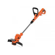 Black & Decker BESTA530 corded grass strimmer with orange and black body, long shaft, and cutting head against white background