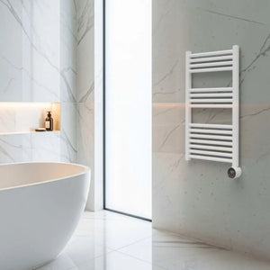 White heated towel rail with horizontal bars mounted on marble-effect wall in modern minimalist bathroom with freestanding white bathtub and skylight window