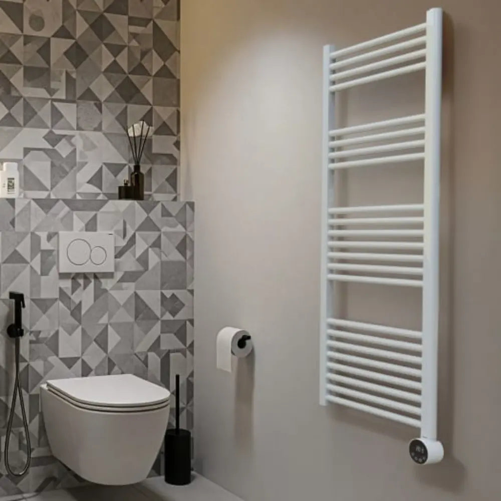 White heated towel rail mounted on bathroom wall beside toilet with geometric patterned tiles, modern minimalist bathroom design