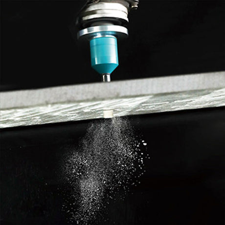 Diamond brazed tile drill bit 6mm with blue coolant reservoir and metal chuck spraying water mist onto wooden surface against black background