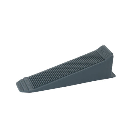 Gray plastic tile levelling wedge shown from angled side view with ridged surface and tapered design for construction use