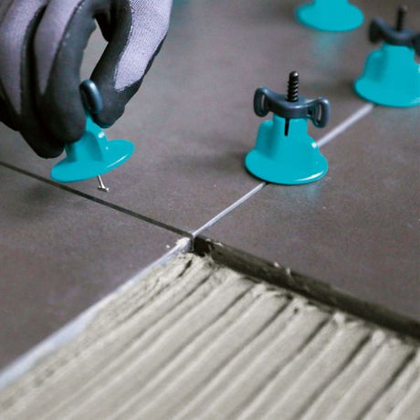 Bihui T Spin Levelling System 1.5mm spacers displayed in 50 pack showing turquoise blue plastic clips and grey levelling wedges arranged on textured surface