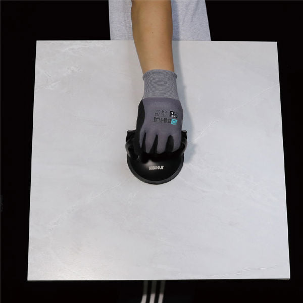 Hand wearing gray work glove with black suction cup tool demonstrating Bihui single head aluminum alloy suction cup on white surface