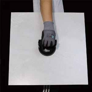 Hand wearing gray work glove with black suction cup tool demonstrating Bihui single head aluminum alloy suction cup on white surface