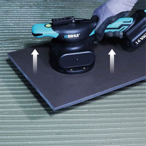 Bihui CVT Vibration Tile Beater with black body and turquoise handles mounted on dark grey base plate with white directional arrows, shown on green wooden surface with battery pack visible