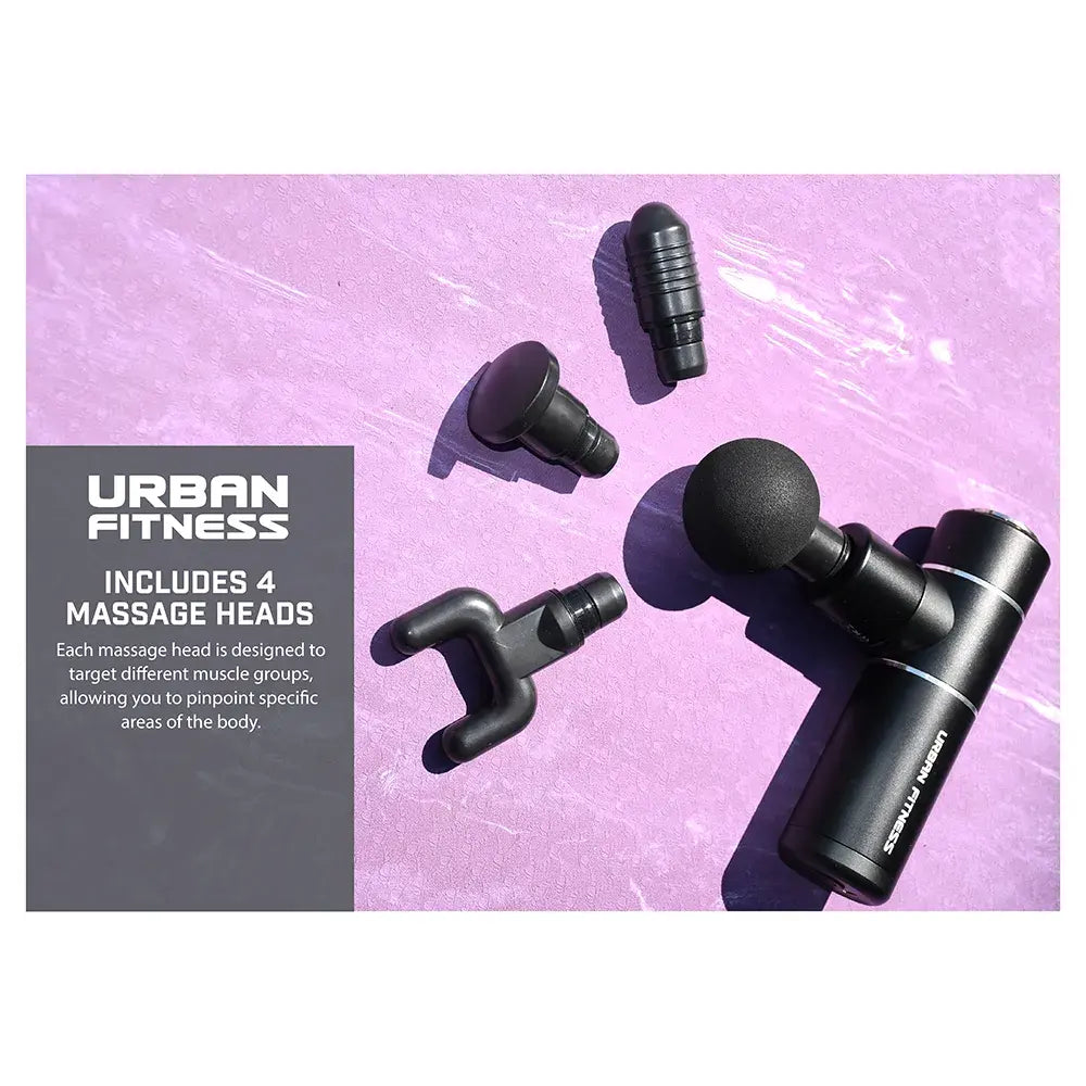 Urban Fitness mini massage gun in black with four interchangeable massage heads displayed on pink background, including ball, fork, and specialized attachment heads for targeted muscle relief