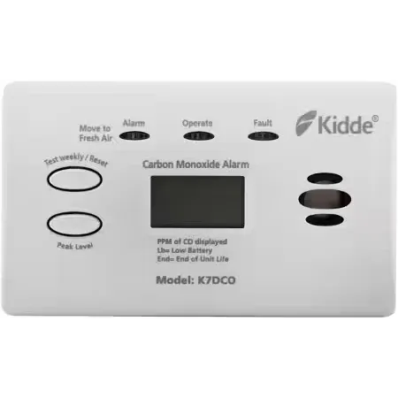 Kidde K7DCO carbon monoxide alarm with white plastic casing, digital display showing PPM of CO levels, battery status indicator, and control buttons for alarm test, reset, and silence functions