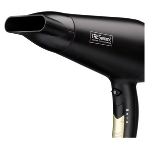 TRESemmé Salon Professional 2200W black hairdryer with oval nozzle attachment and cream-colored handle grip shown against white background