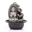 Gray stone Buddha tabletop water fountain with stacked rocks and cascading water feature in black basin with LED light sphere on white background