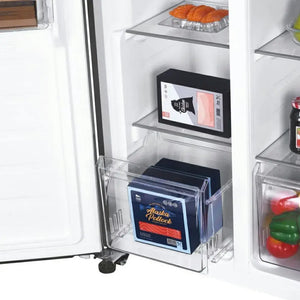 Interior view of Candy 442L frost free American fridge freezer showing stainless steel shelves with fresh croissants, Alaska Pollock packaging, pink cosmetic items, and fresh vegetables including red and green peppers in door compartments