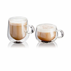 Two clear double-walled glass mugs filled with a latte, one larger and one smaller, shown on a white background with soft reflections below.