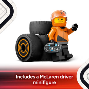 LEGO minifigure in orange and black McLaren racing suit with orange helmet standing next to large black racing tire with orange trim and digital display device, product image for LEGO F1 Driver with McLaren Race Car set 60442