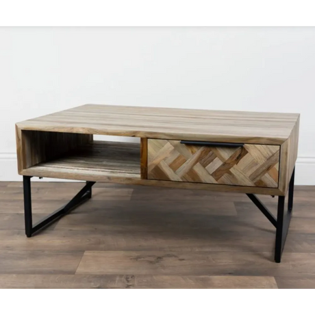 Tara Lane Verona coffee table in teak wood with herringbone patterned drawer front, open shelf compartment, and black metal legs on wooden flooring