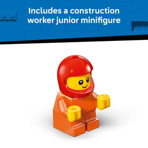 LEGO construction worker junior minifigure with red helmet, yellow face, orange torso and legs, and yellow hands, displayed against blue LEGO brick background