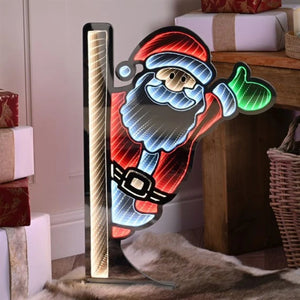 Festive standing waving Santa neon light sign with red suit, blue trim and green mittens, featuring infinity mirror effect with warm gold vertical stripe, mounted on black metal stand in modern home interior
