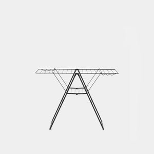 Black metal winged clothes airer with extended horizontal drying bars and folding tripod legs, front view against white background