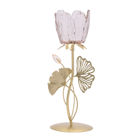 Decorative candle holder with pink glass shade and gold metal base on a white background
