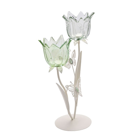 Hestia two stem candle holder featuring green and clear glass tulip-shaped cups with decorative butterflies on matte off-white metal base and stems