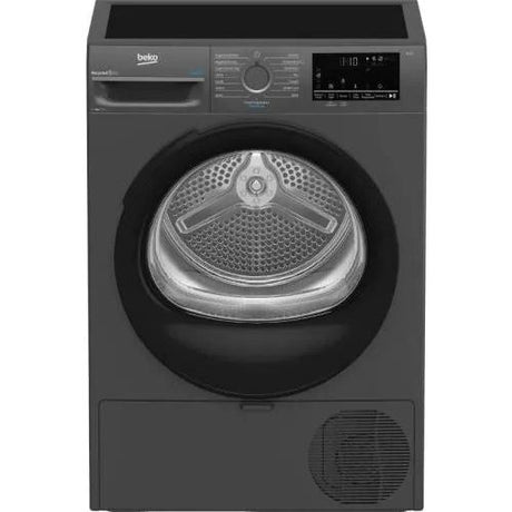 Beko 9kg heat pump tumble dryer in anthracite grey with digital display, vented grille at bottom, and stainless steel drum visible through black door frame