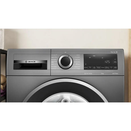 BOSCH Series 6 graphite grey front-load washing machine with 9kg capacity, 1400 spin speed, featuring a large circular door, control panel with large dial, digital display showing 4:25, and AntiStain technology label visible on the right side
