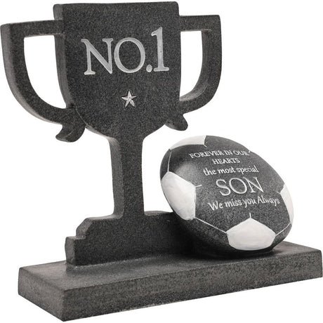 Dark grey granite memorial plaque featuring a No.1 trophy cup with handles and a carved football, engraved with tribute text for a son including "Forever in our hearts" and "We miss you always"