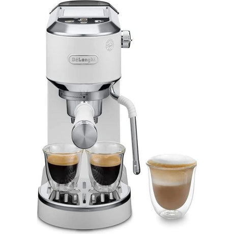 DeLonghi Dedica Duo white espresso machine with dual spout dispensing two shots of espresso into glass cups, featuring stainless steel accents and control knob, displayed with separate latte cup