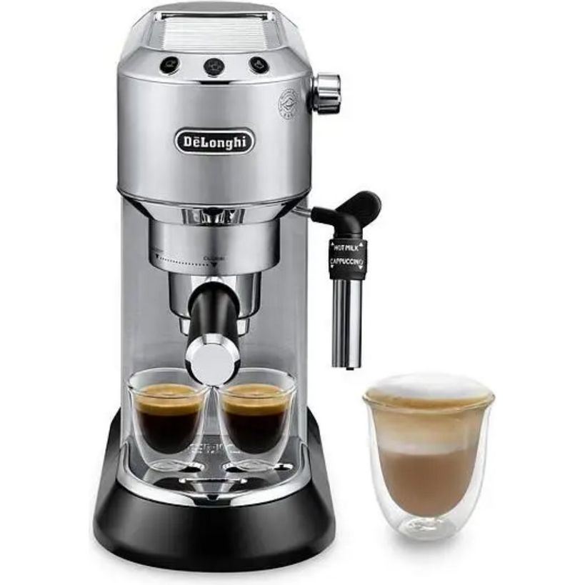 DeLonghi Dedica stainless steel pump espresso machine with black base dispensing two shots of espresso into glass cups, featuring milk frother attachment on side and separate glass cup of cappuccino displayed to the right