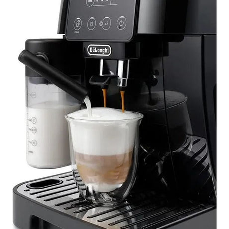 DeLonghi Magnifica Start black automatic espresso machine dispensing cappuccino into glass cup with milk frother and bean hopper visible