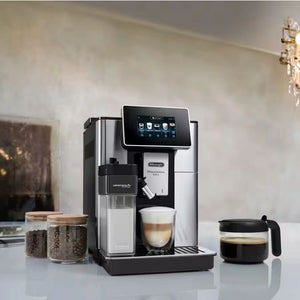DeLonghi PrimaDonna Soul automatic coffee machine in stainless steel and black with touchscreen display, milk frother, water tank and coffee bean containers on white countertop
