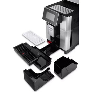 DeLonghi PrimaDonna Soul automatic coffee machine in metal black showing disassembled components including water tank, drip tray, grounds container and removable parts on white background