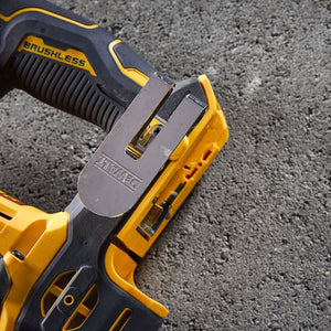 DeWalt DCH172P2 compact brushless SDS plus rotary hammer drill in yellow and black with two lithium-ion batteries displayed on concrete surface showing trigger, battery compartment and product branding
