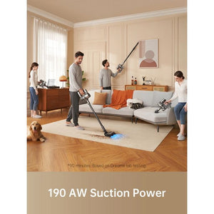 Family using Dreame R20 cordless stick vacuum with 190 AW suction power in beige and cream living room with wooden floors, orange accents, and dog, demonstrating cleaning capability on light carpet