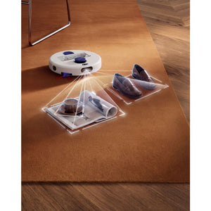 Dyson R2 Nurovi robot vacuum with white and navy design demonstrating wet and dry cleaning on terracotta carpet, showing transparent collection bins with filters and cleaning attachments, with wooden flooring visible in background