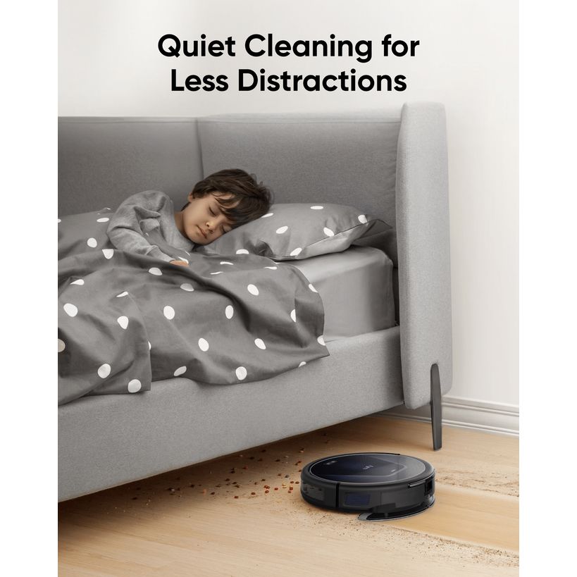 eufy RoboVac G50 Hybrid cleaning quietly beside a bed while a child sleeps