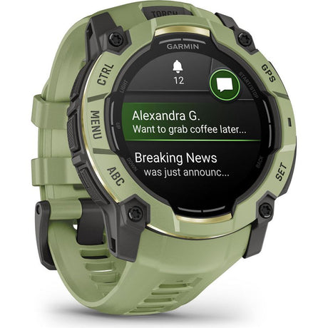 Garmin Instinct 3 smartwatch with 50mm AMOLED display in fern green silicone band showing notifications from Alexandra G and Breaking News on black screen with time 12 o'clock