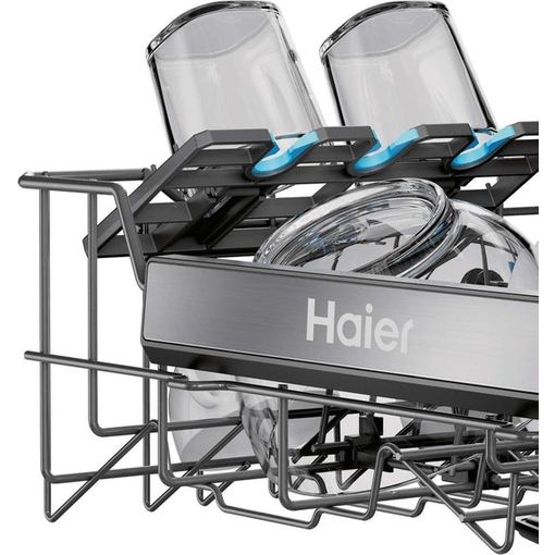 Haier I Pro Shine Series 3 white dishwasher with open door displaying upper rack with blue handles and lower rack with chrome spray arm and cutlery basket