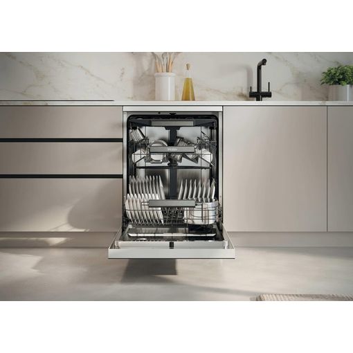 Haier I Pro Shine Series 3 white dishwasher with open door showing place settings, integrated into modern kitchen cabinetry with marble backsplash and stainless steel countertop