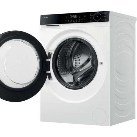 Haier X Series 5 white washer dryer combo with black trim and open door showing internal drum, digital display panel visible on top